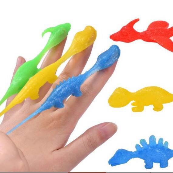 Tiro de dinossauro brinquedos divertidos de dedos de tiro de dedos de lançamento de pequenos dinossauros de despressão de softgels transfronteiriços Novas fontes de atacado