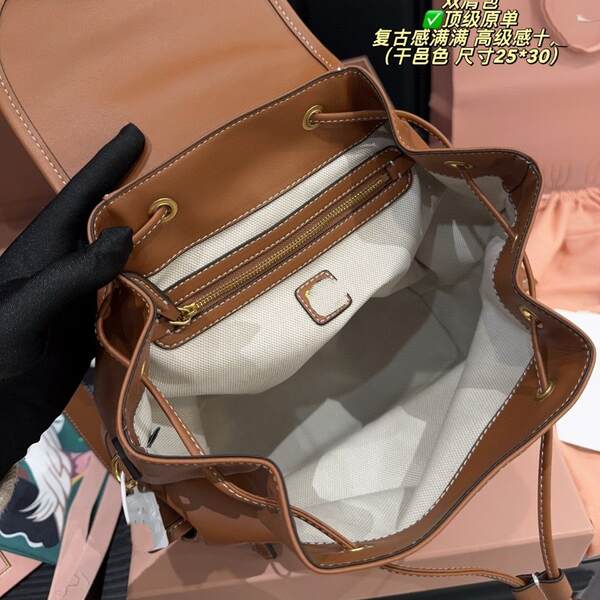 Miu Mu2025 nova mochila de couro duplo de ombros de alta sensibilidade de mão de ombro único de trabalho real mochila femininas atacado