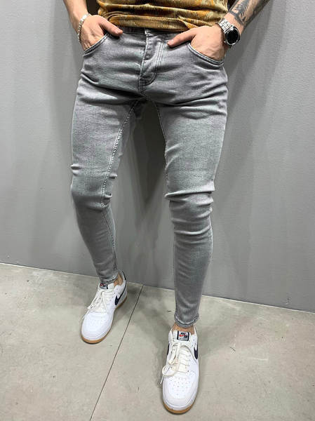 Jovens europeus e americanos de alta qualidade com as pernas apertadas de jeans independentes de comércio exterior