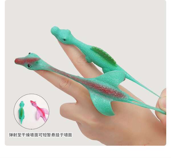 Tiro de dinossauro brinquedos divertidos de dedos de tiro de dedos de lançamento de pequenos dinossauros de despressão de softgels transfronteiriços Novas fontes de atacado