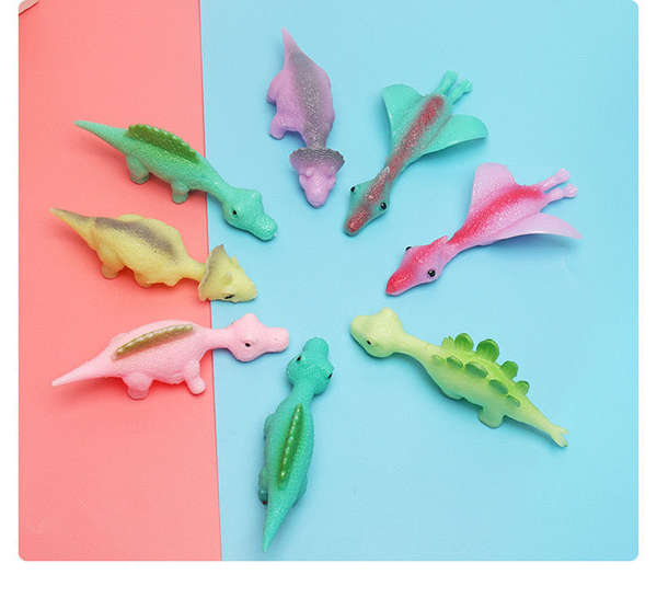 Tiro de dinossauro brinquedos divertidos de dedos de tiro de dedos de lançamento de pequenos dinossauros de despressão de softgels transfronteiriços Novas fontes de atacado